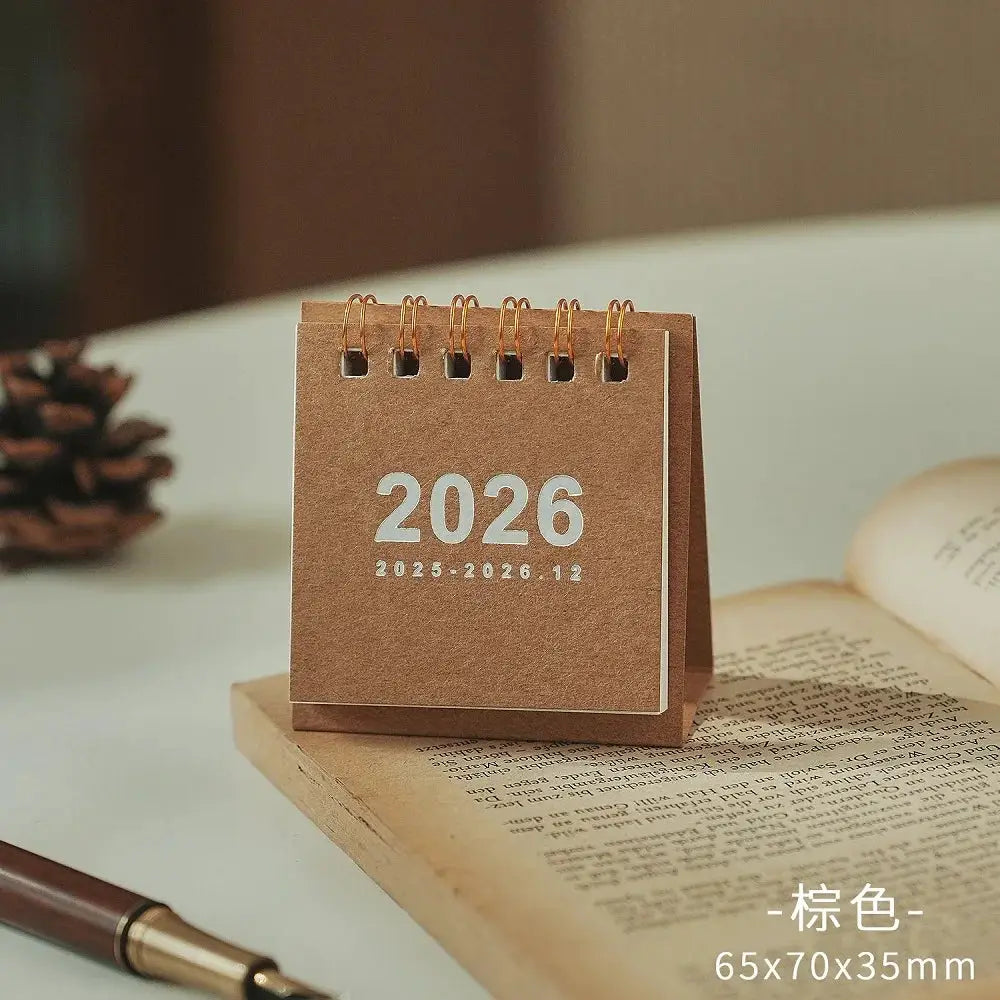 Mini 2026 desk calendar with copper coil binding on brown kraft board