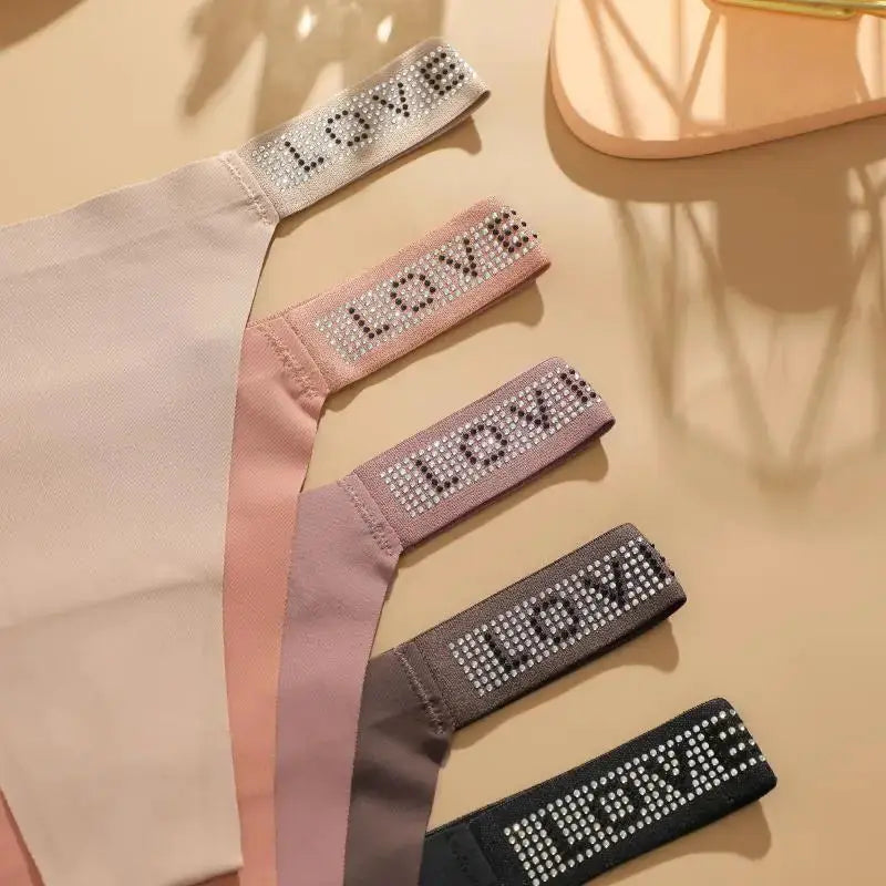 7-pack women's low-waist thong set with crystal-letter straps in white, pink, lavender, gray, and black; breathable