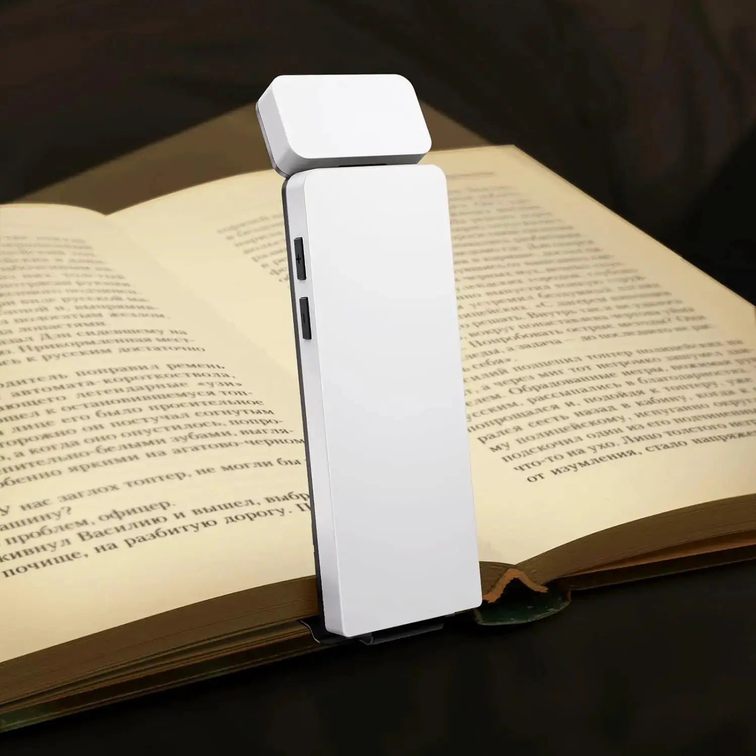 LED clip-on book light by Simples Market; white compact bookmark-style lamp clipped to a book