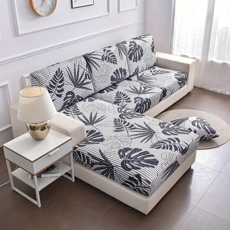 Elastic sofa cushion cover set for L-shaped corner couch in white with black botanical leaves; removable and anti-dust.