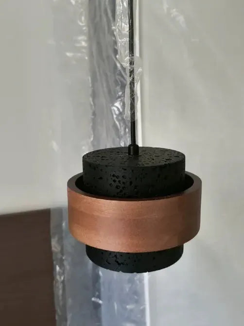 Japanese Wabi Sabi bar pendant lamp by Simples Market; black textured pendant with copper wrap and hanging cord.