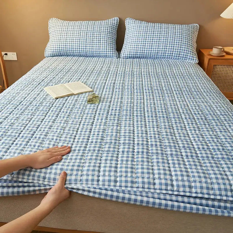 Simples Market quilted plaid mattress protector in blue and white gingham; antibacterial cover with two pillows.