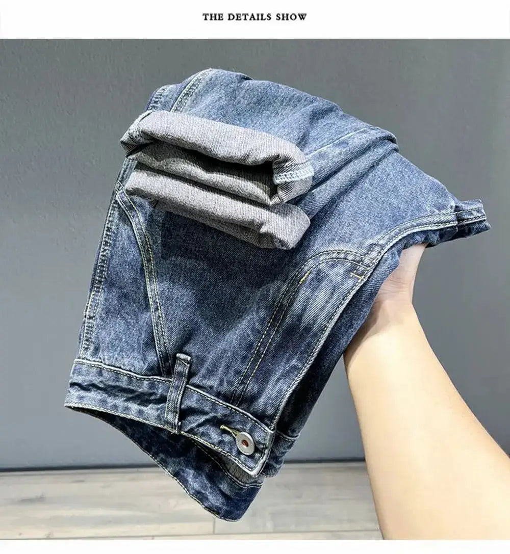 Men's Korean vintage loose tapered denim jeans in blue with rolled cuffs