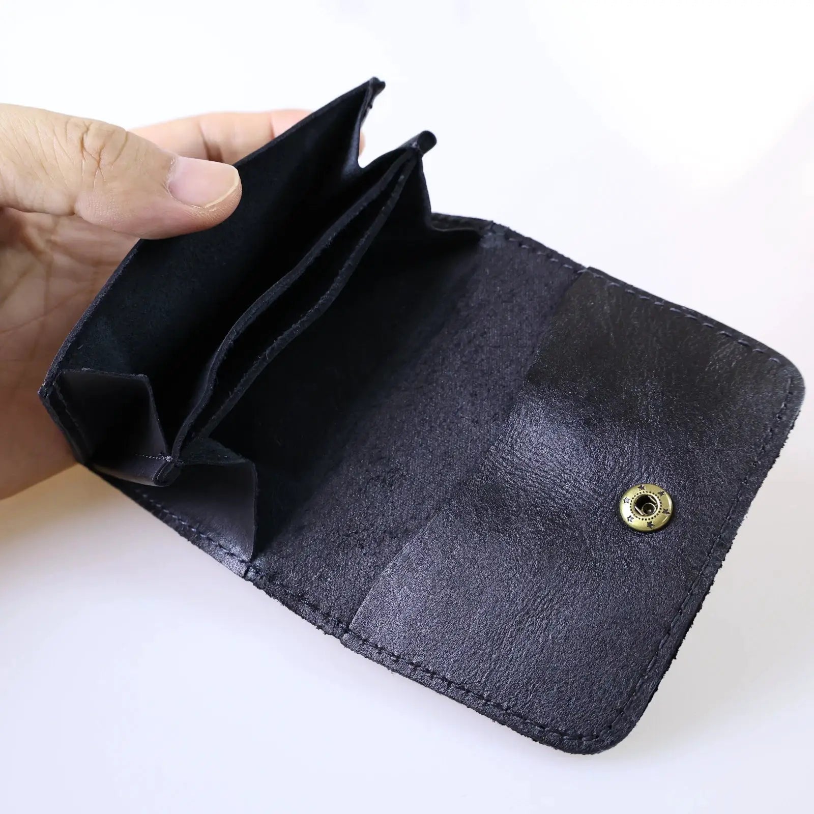 Genuine cowhide leather wallet in black with multiple card slots and a snap closure