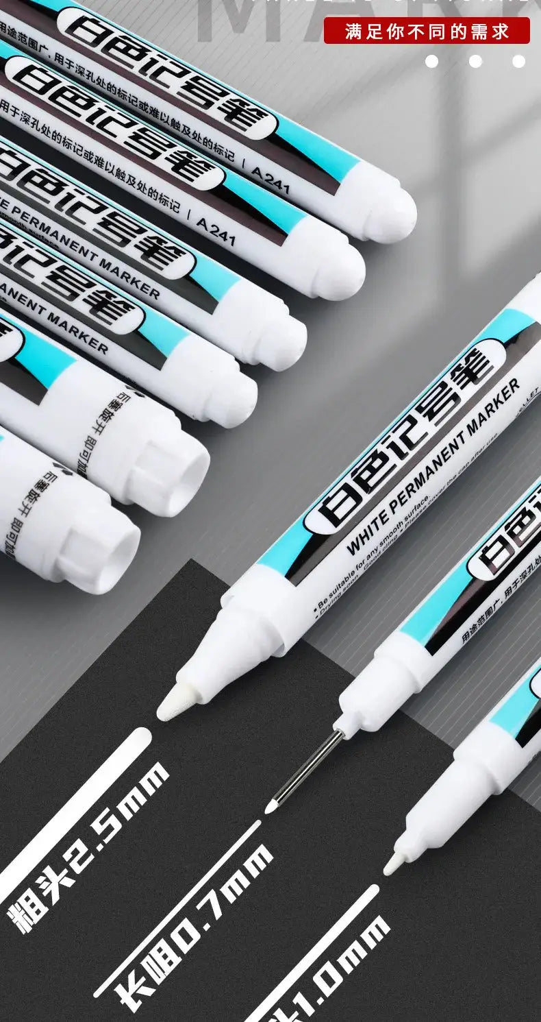 Simples Market white permanent marker pens set with 2.5mm, 1.0mm and 0.7mm tips on a dark surface