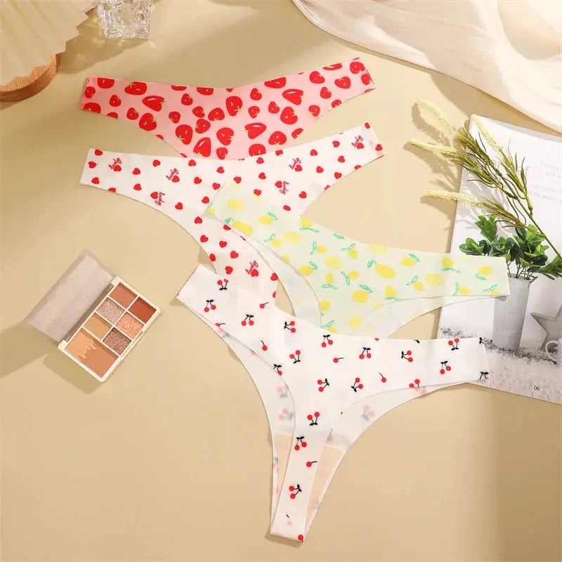 4-pcs women's thong set; ultra-soft seamless underwear with cherry, heart and lemon prints on white.