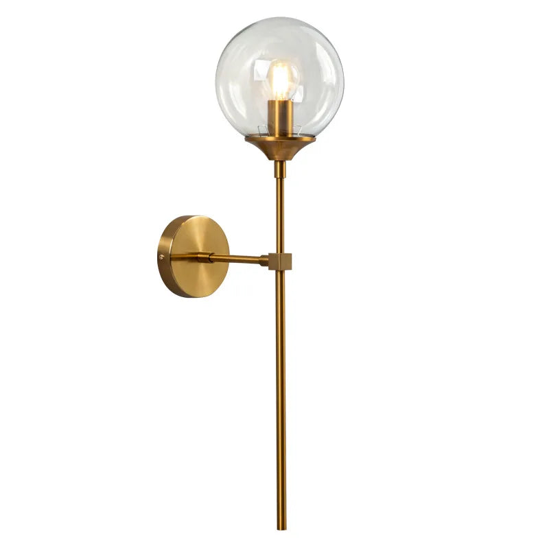 Modern glass ball wall lamp in brass gold finish with clear globe