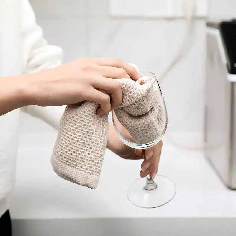 Dishcloth by Simples Market, beige 100% cotton, ultra-soft absorbent kitchen towel used to dry a wine glass.