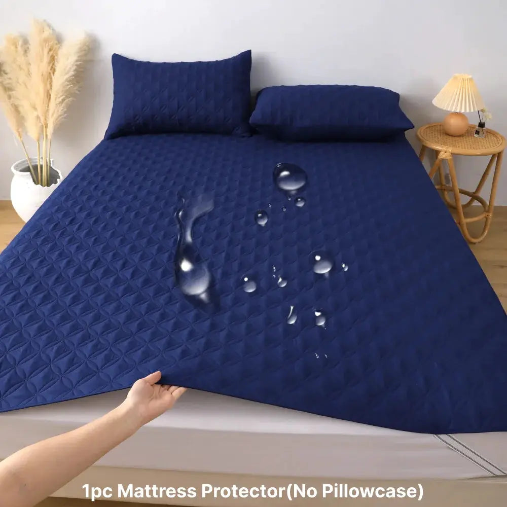 Quilted navy blue waterproof mattress protector with elastic band for bed.