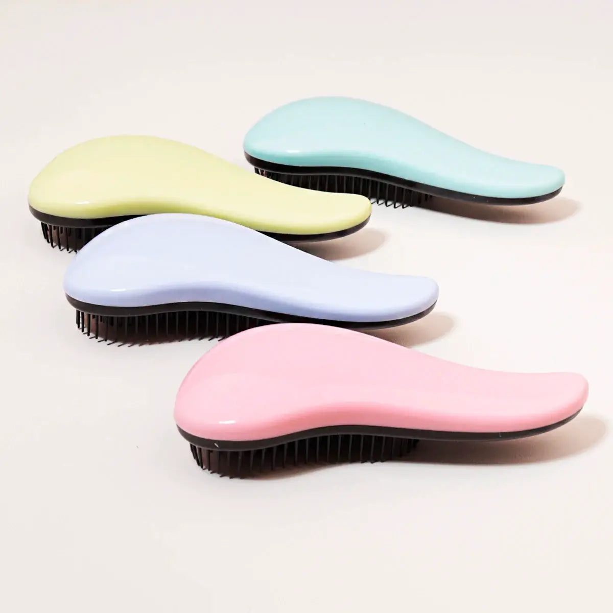 Antistatic massage brushes – set of five pastel-colored curved brushes with black bristles
