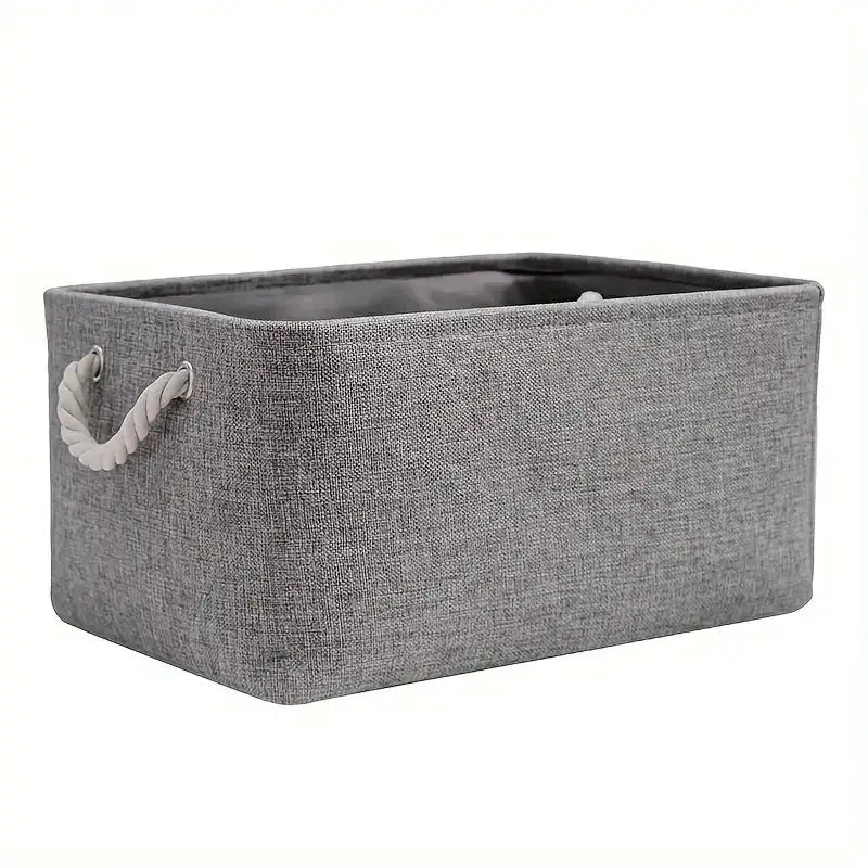 Folding linen fabric storage basket in grey with rope handles.