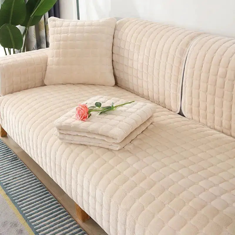Beige quilted flannel sofa cushion set with non-slip backrest and seat covers; includes 1 pillow and 1 folded blanket.