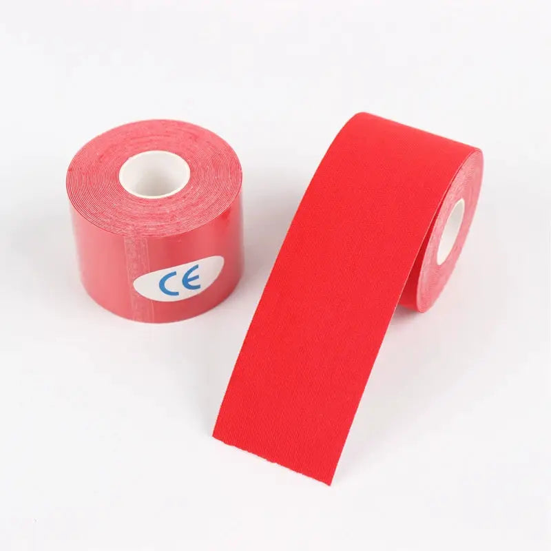 Two red kinesiology tape rolls with a partially unrolled strip and a CE sticker