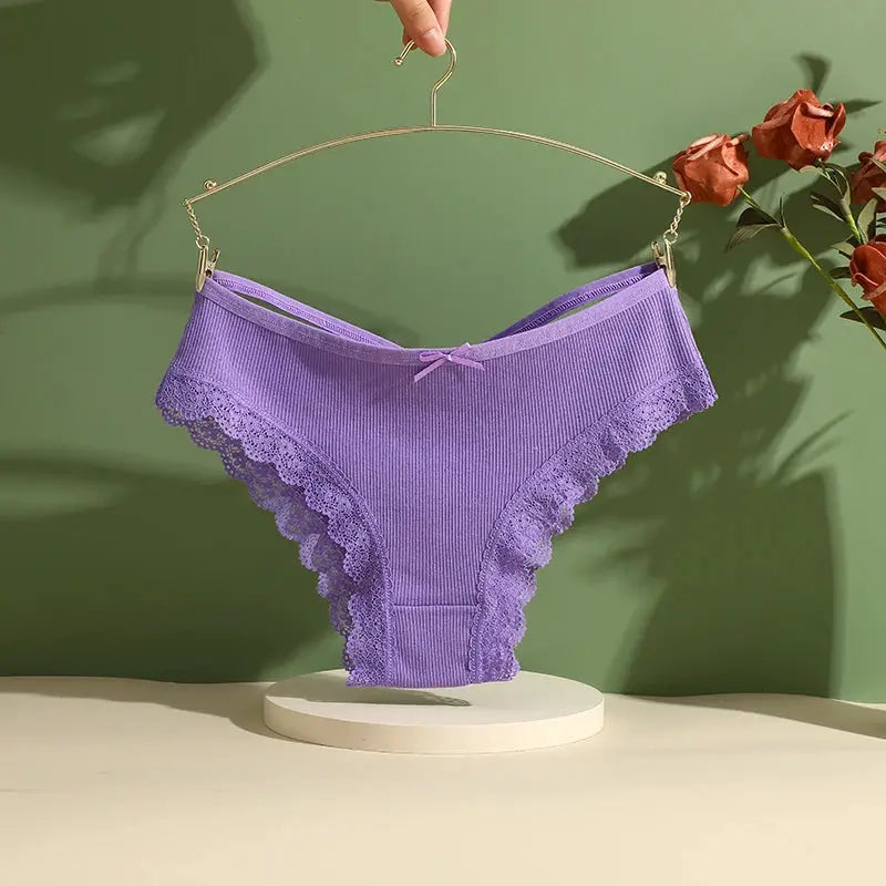 Purple lace-trimmed cotton panties with bow, low-rise bikini style on a hanger