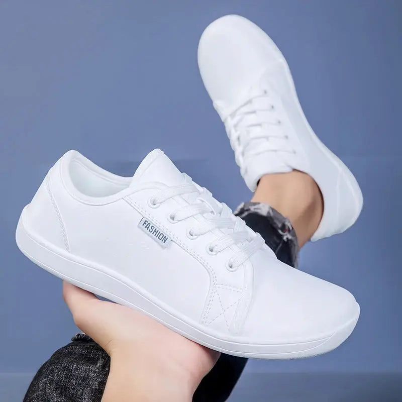 White walking sneakers with laces and a flat, lightweight sole