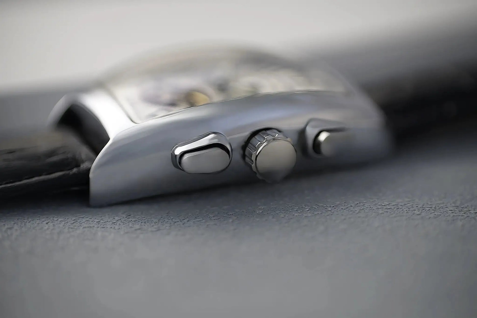 CASENO luxury men's automatic skeleton watch with a silver-toned tonneau case and crown (side view)