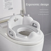 White baby and child toilet seat ring with ergonomic high backrest and side grips on a standard toilet