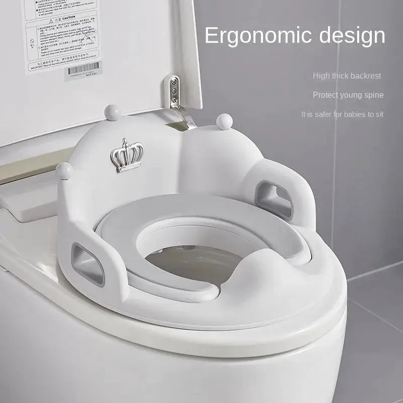 White baby and child toilet seat ring with ergonomic high backrest and side grips on a standard toilet