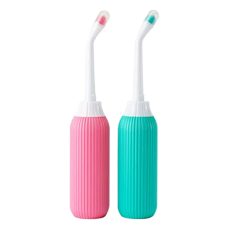 Portable bidet set of 2 by Simples Market with pink and teal bottles and curved nozzles.