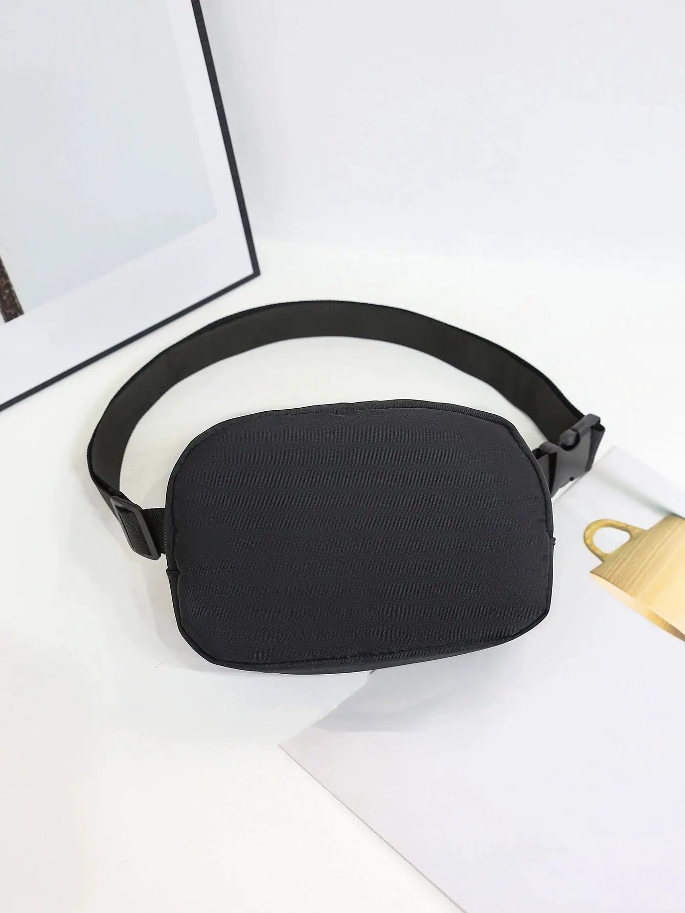 Black sport waist bag with adjustable strap, compact oval phone pouch