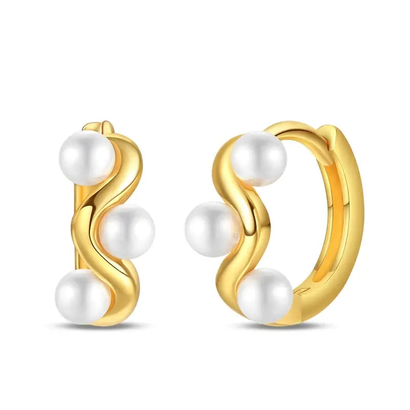 Gold-tone pearl hoop earrings pair with a wavy design and white pearls
