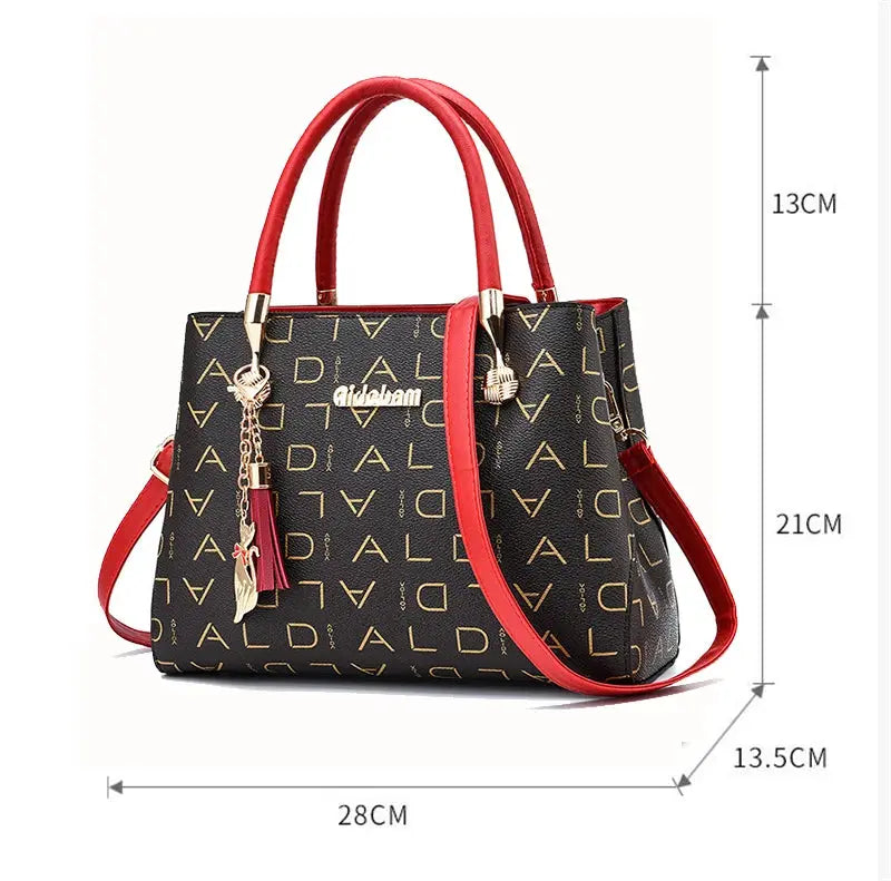 PU leather crossbody bag for women, black with repeated gold lettering pattern, red handles and strap, large-capacity