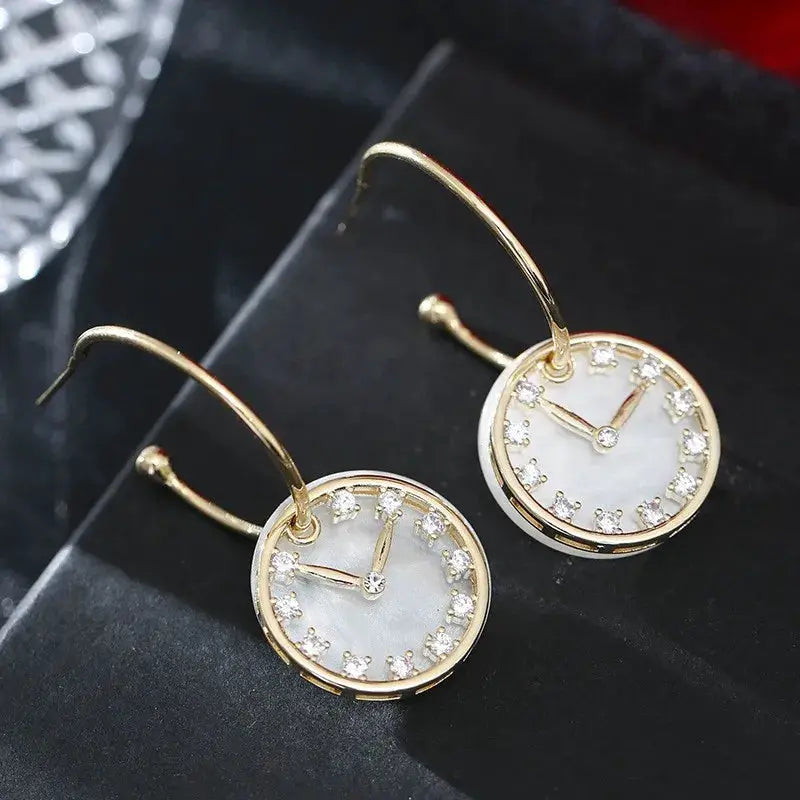 Clock earrings by Simples Market: gold-tone round faces with crystal accents and mother-of-pearl dial, set of 2