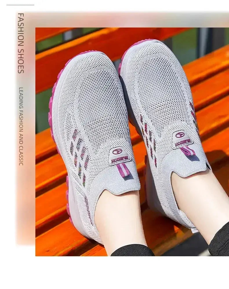 Simples Market women's wide-toe slip-on breathable sneakers; grey mesh upper with pink accents, pair.
