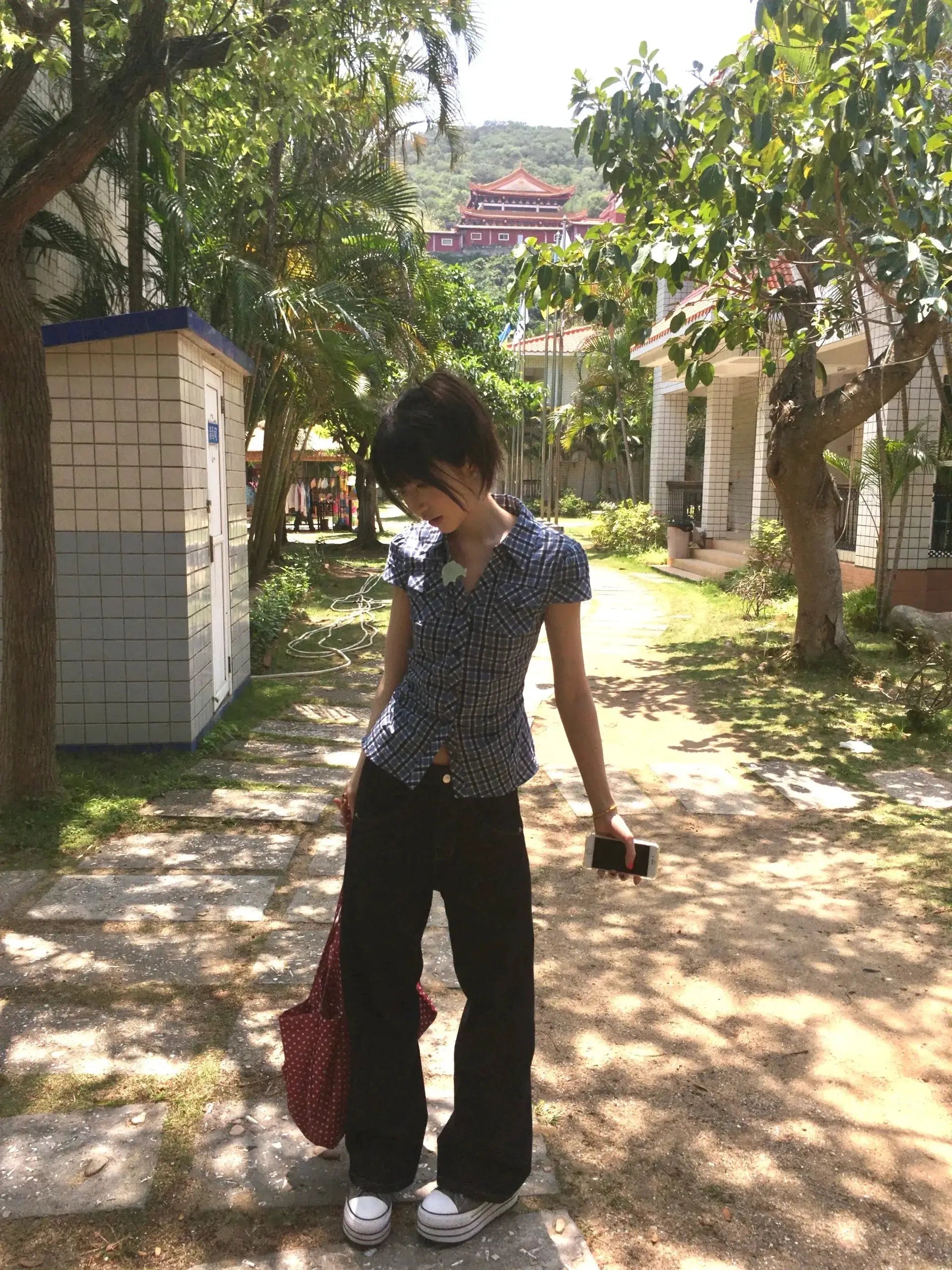 Karrram Japanese Y2k plaid shirt, blue checkered V-neck short-sleeve worn by a woman outdoors.