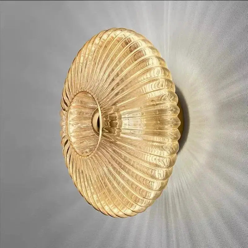 Nordic LED glass wall sconce in amber gold, ribbed circular design; Simples Market