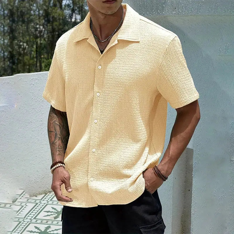 Men's short-sleeve casual shirt in beige textured fabric, relaxed baggy fit for streetwear style.