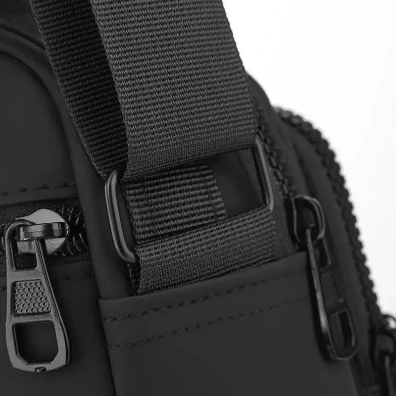 Simples Market black messenger sling bag with adjustable nylon strap and metal zippers, compact crossbody phone pouch.