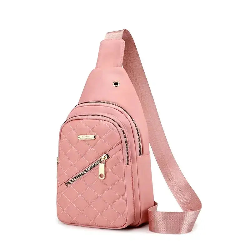 Simples Market pink quilted crossbody bag with gold zippers and wide strap.
