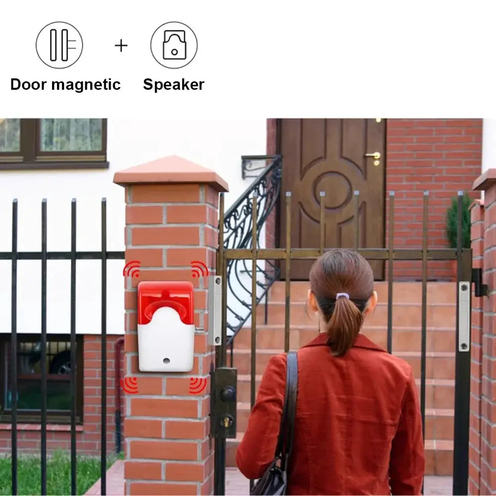 Door sensor magnetic contact on brick pillar with red/white housing; security reed switch
