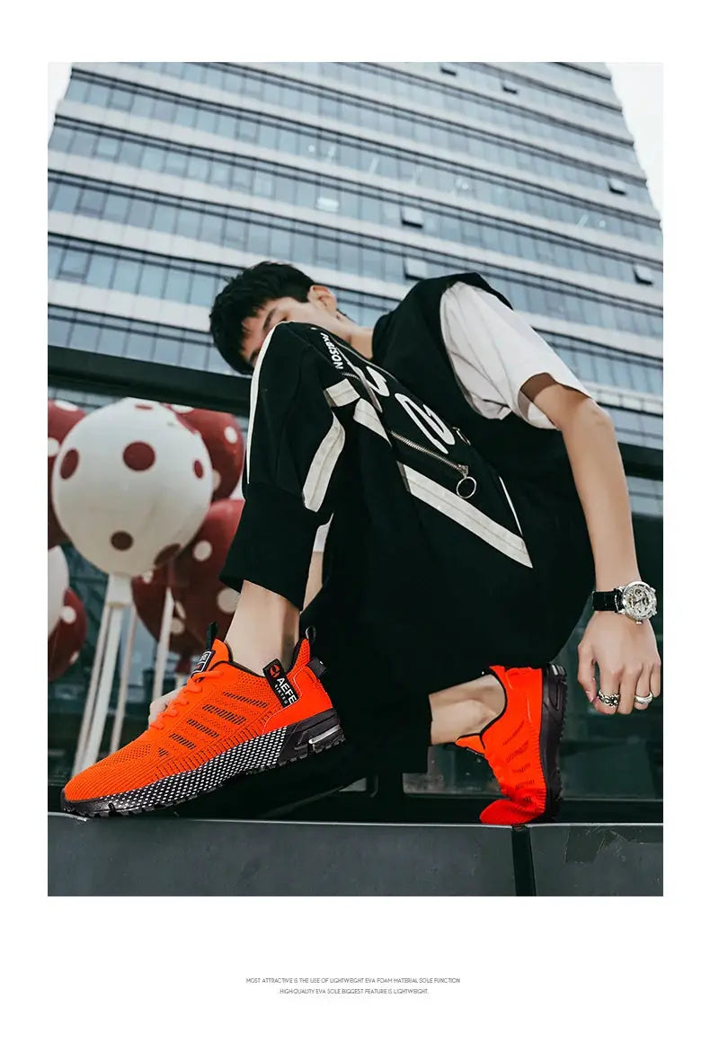 Men's orange running sneakers with breathable knit upper and black speckled sole for lightweight athletic training