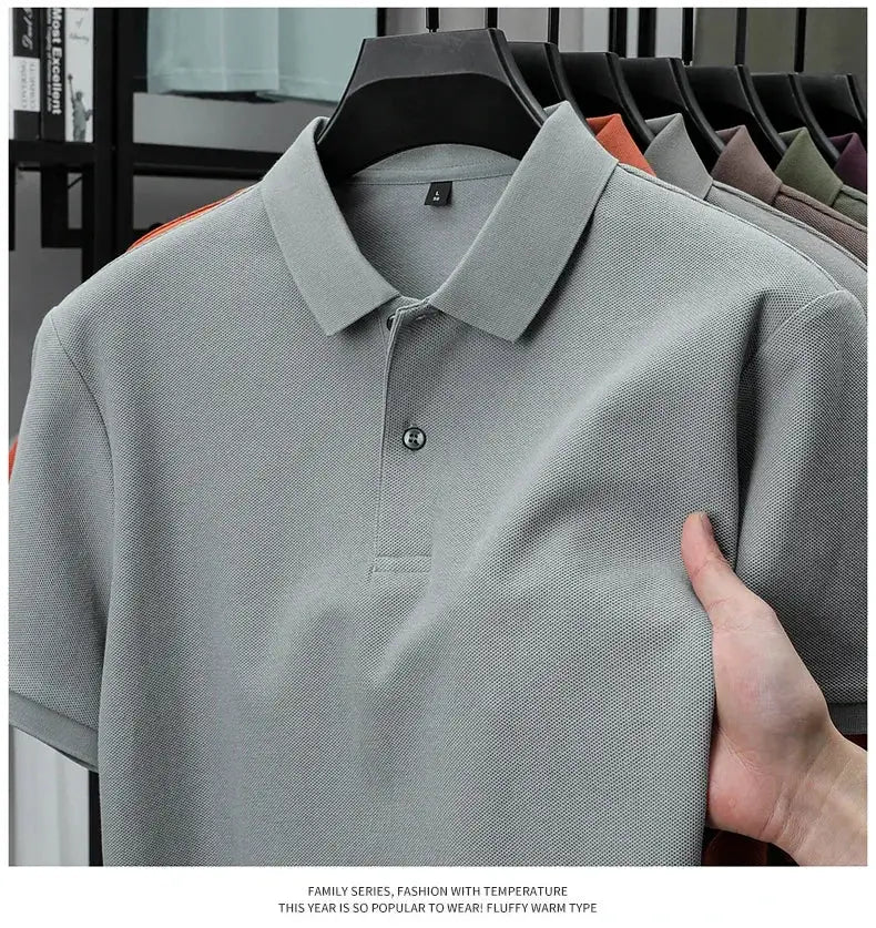 Men's 100% cotton polo shirt in gray, textured knit, on hanger with other colors in background