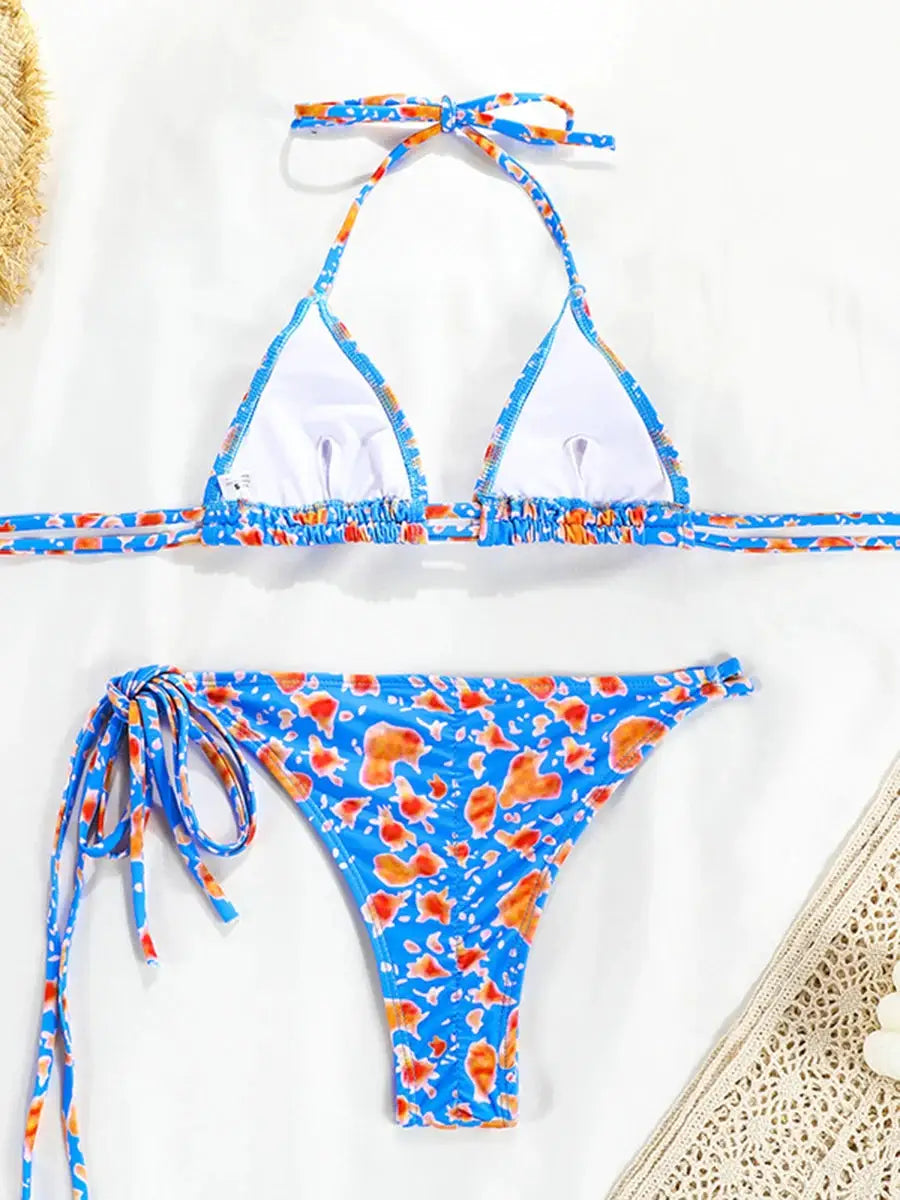 Simples Market blue floral micro bikini set, two-piece thong with halter top and side-tie bottoms.