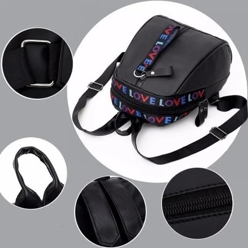 Mini black canvas backpack with colorful LOVE strap and adjustable shoulder strap.