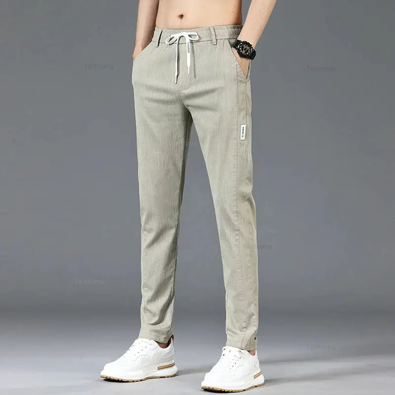 Men's casual pants with elastic drawstring waist; slim straight fit in khaki color with side pockets