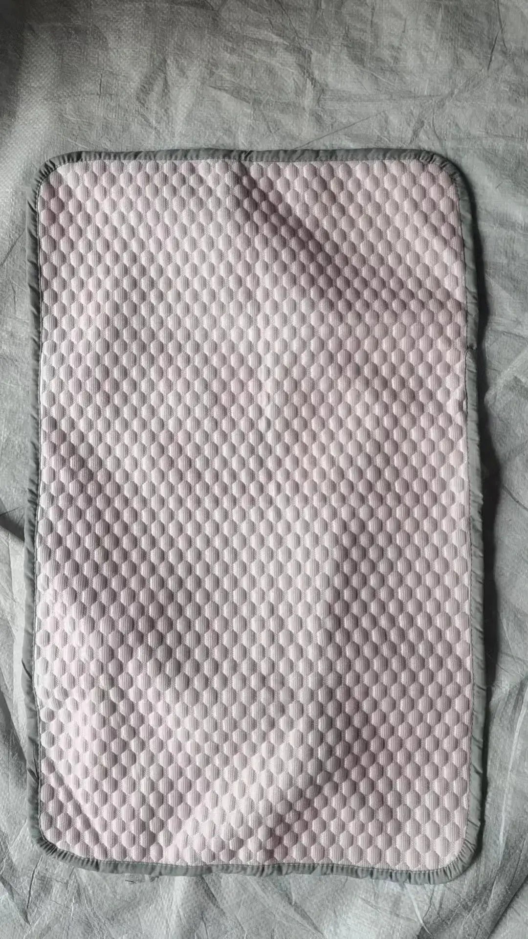 Summer cooling pillowcase, solid soft pink with hexagonal quilted texture and gray edge binding, 48x70 cm