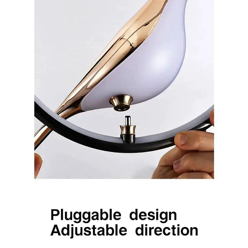 Rotatable magpie LED pendant light by Simples Market in gold and lilac with a black circular hanging ring