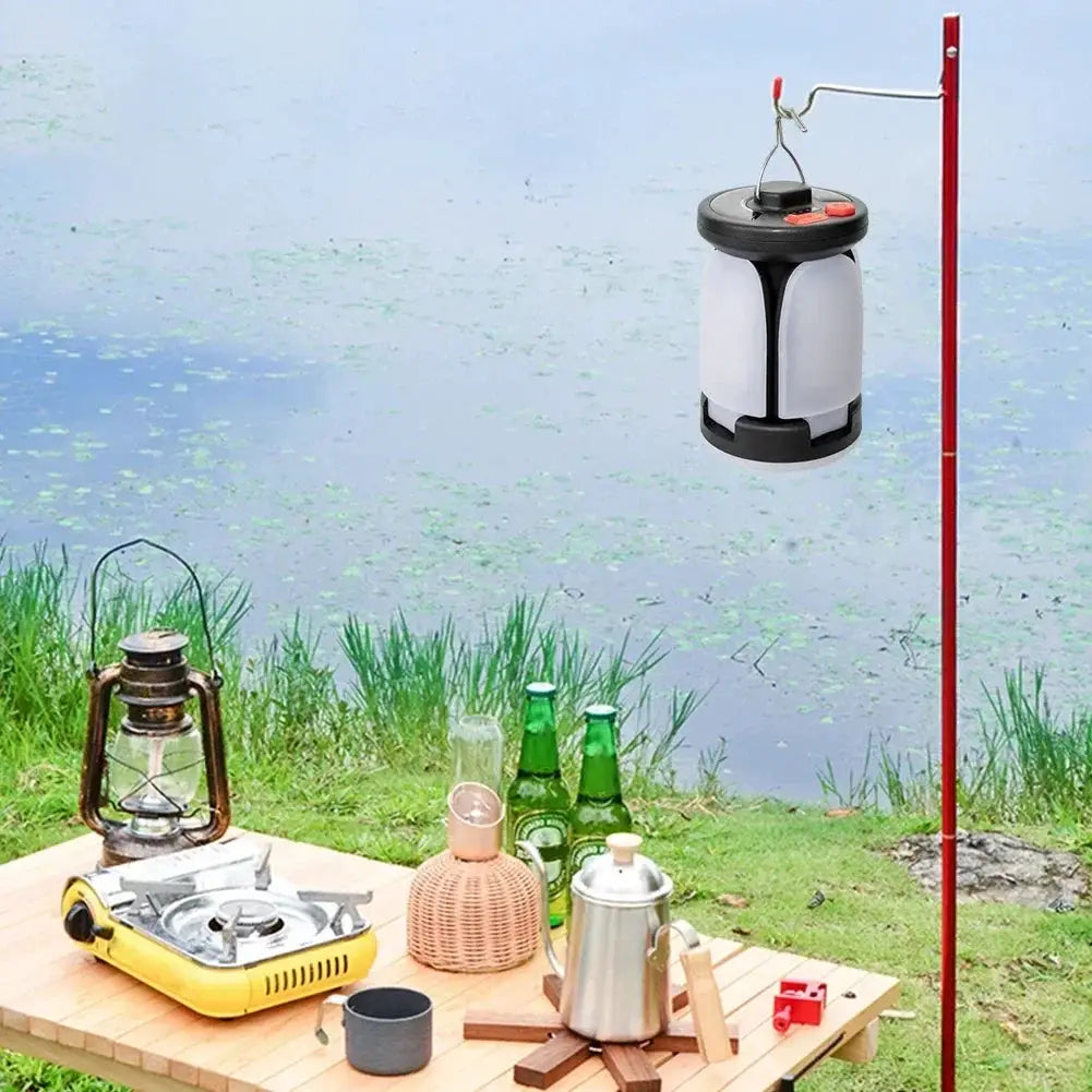 Two camping lanterns: Simples Market LED Leaf hanging solar USB rechargeable tent light, white with black trim.