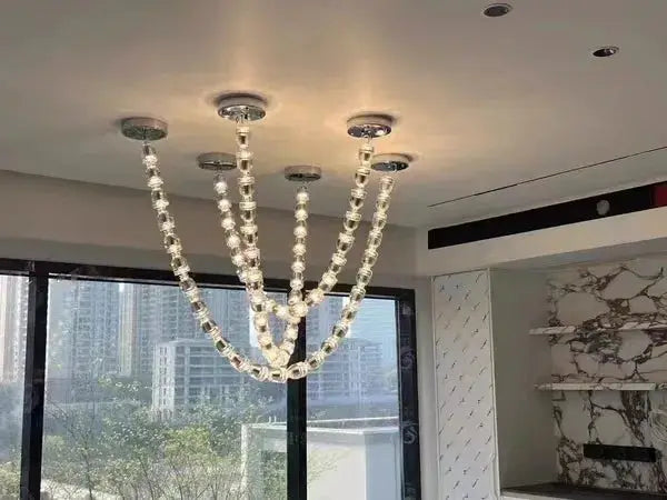 Chandelier ceiling light with multi-strand crystal acrylic beads on adjustable-length chains for living room.