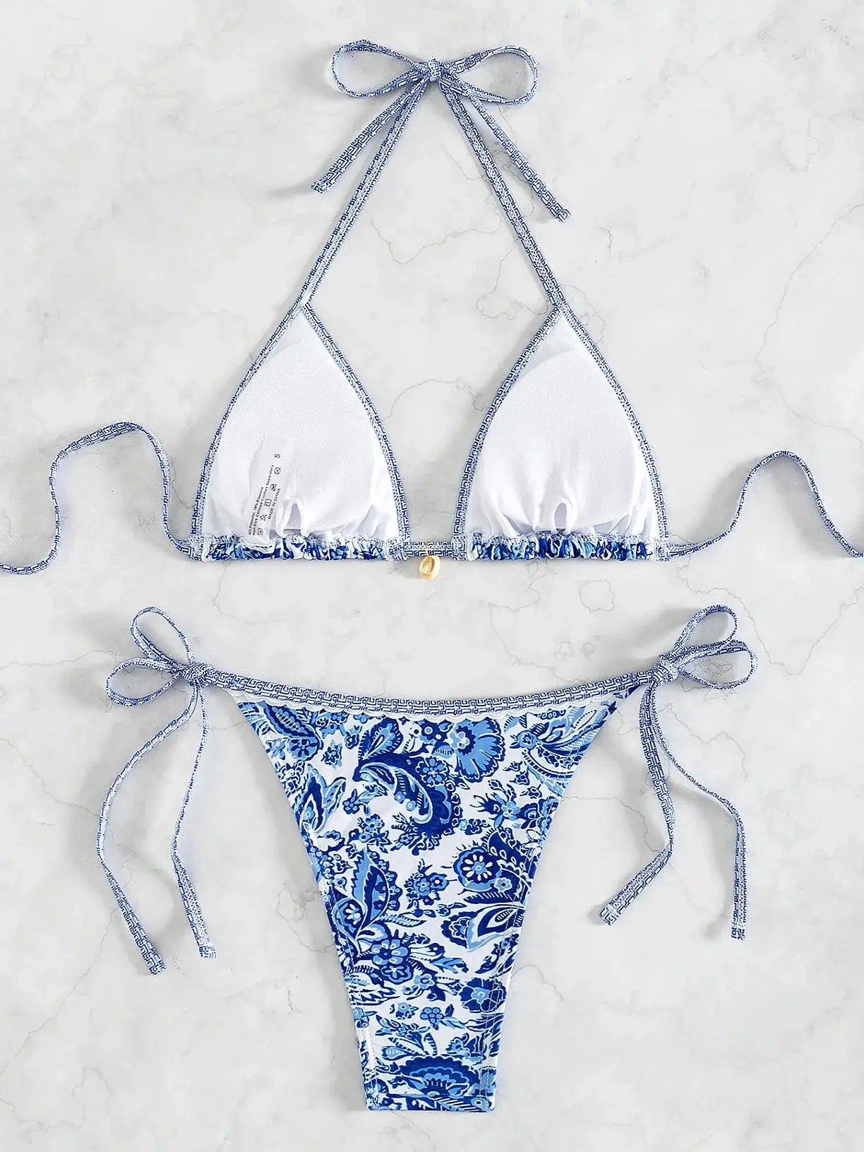 Triangle bikini set by Simples Market with blue floral Brazilian bottoms and white push-up top.