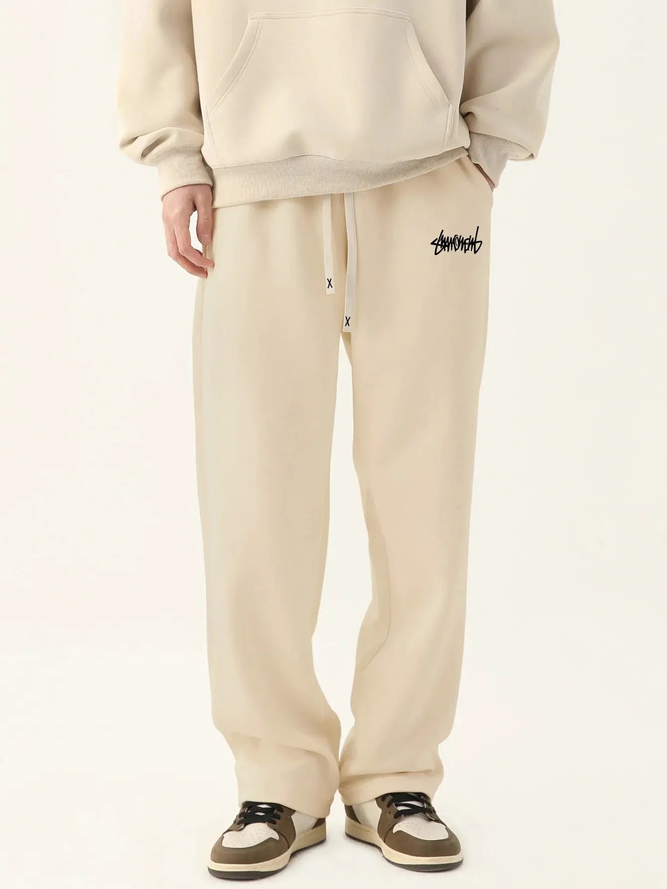 Beige men's baggy jogger pants with drawstring waist and logo on thigh, Simples Market casual outdoor sweatpants