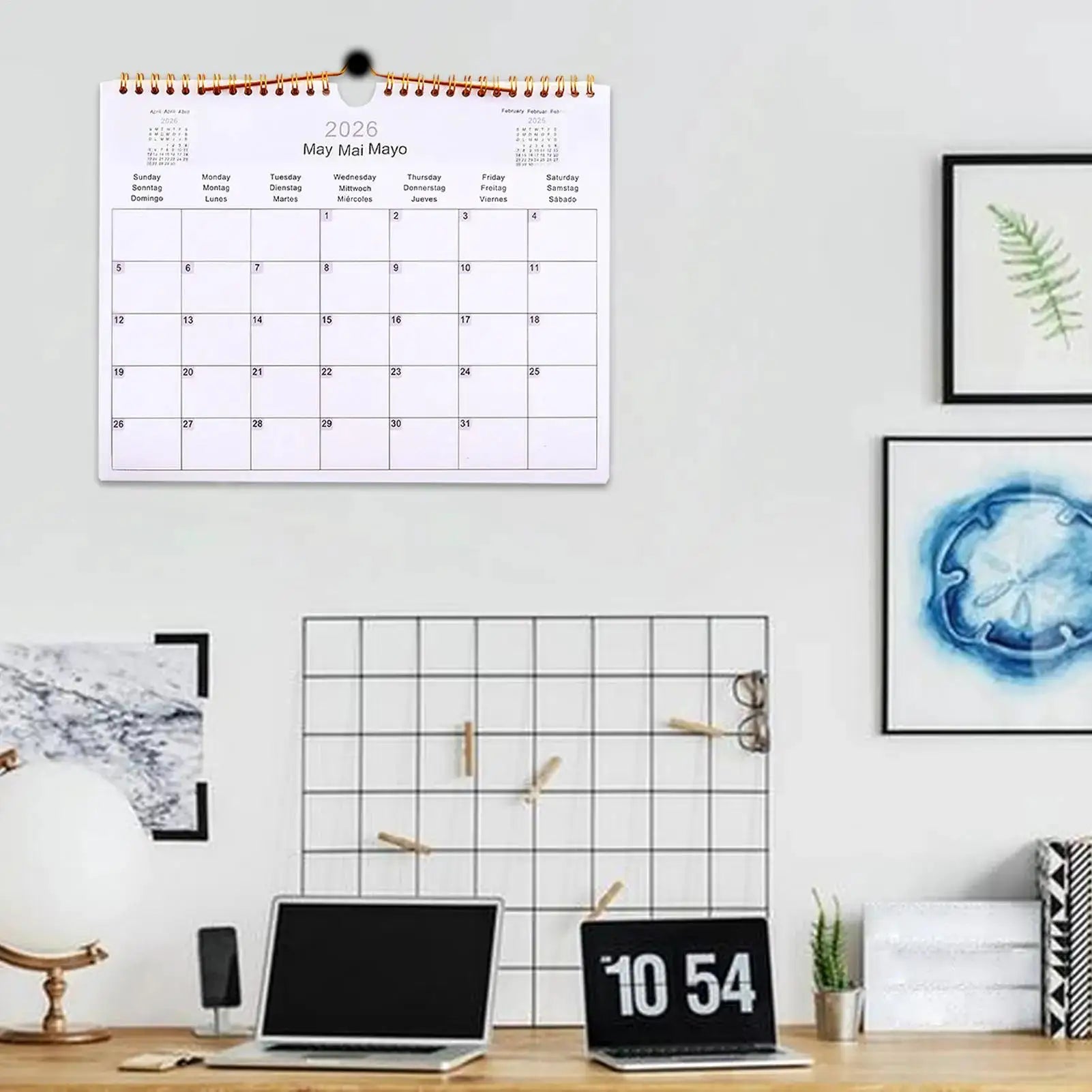 2026 multilingual wall calendar, 12-month coil planner with copper binding by Simples Market hanging on a modern wall