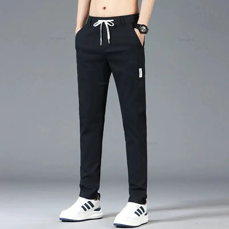 Men's black casual pants with elastic drawstring waist, slim straight fit.