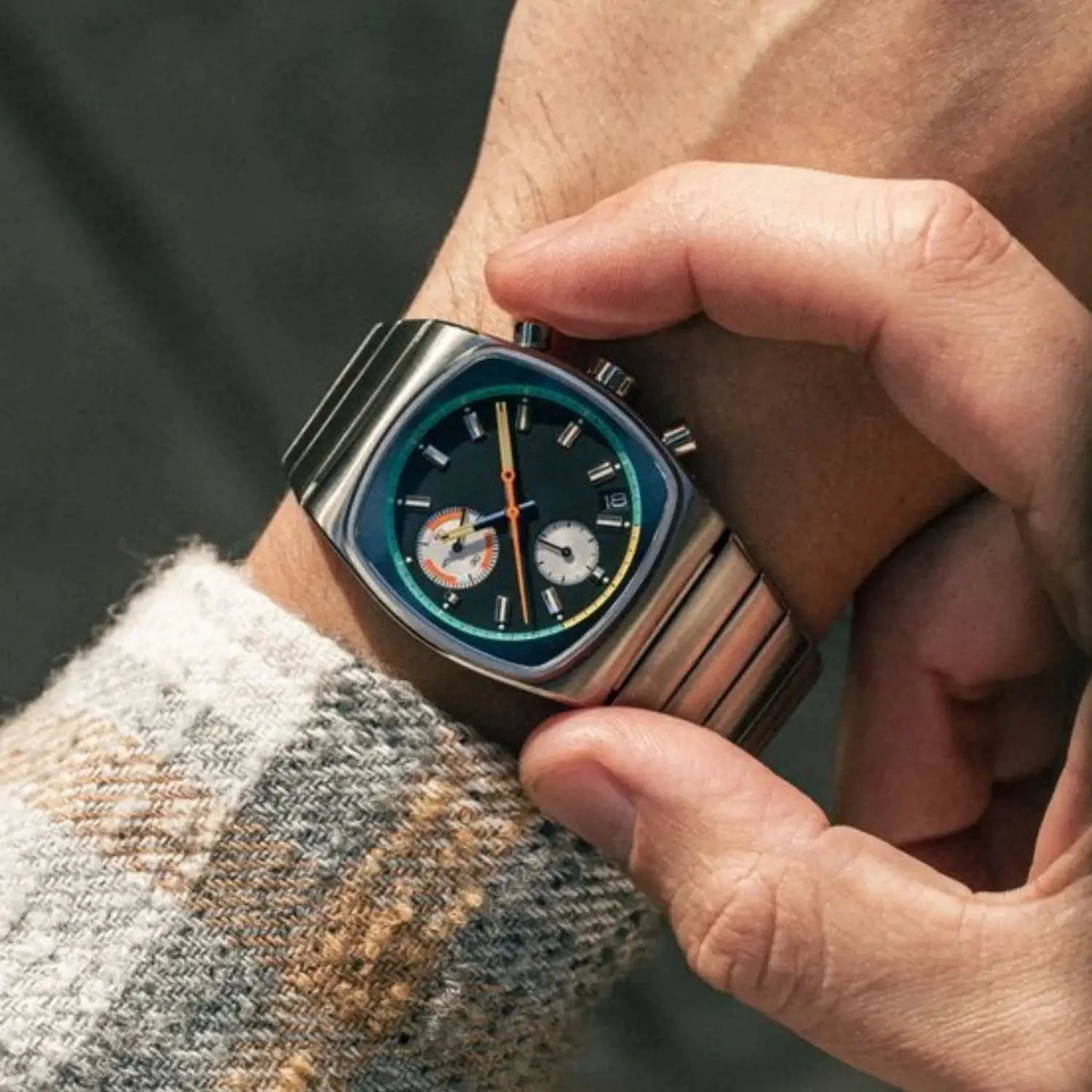 CILOA square men's watch with steel bracelet, black dial, teal inner ring, orange second hand.