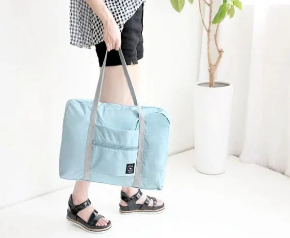 Large-capacity travel bag for unisex use in light blue with dual carry handles by Simples Market
