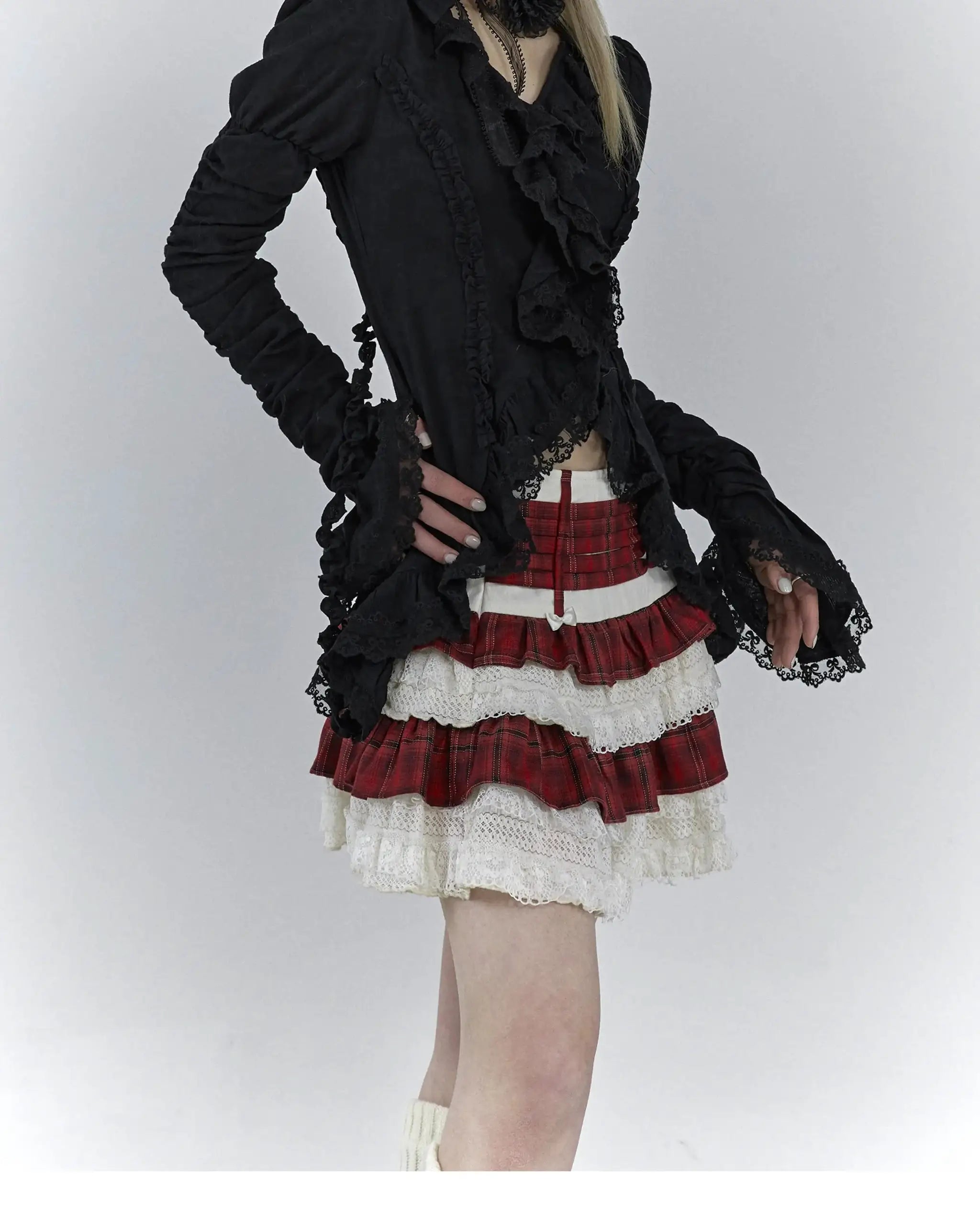 Karrcat Gothic black lace shirt with ruffles and V-neck by Simples Market; paired with a red plaid layered skirt.